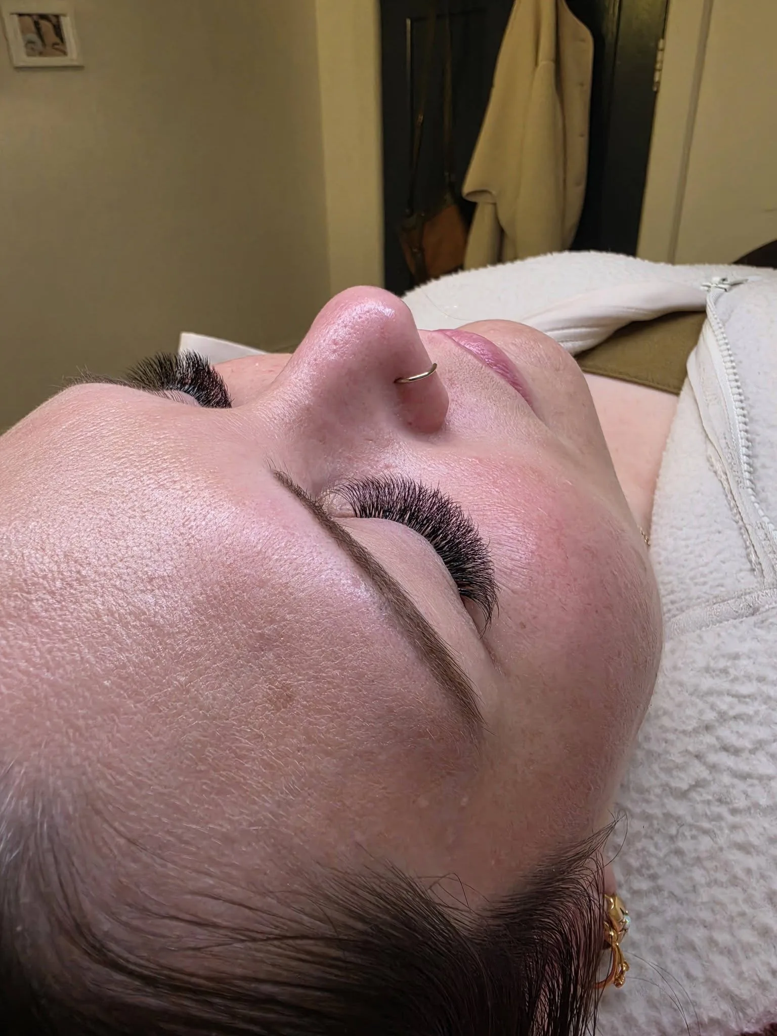 Natural volume lash set — reclined client, side profile